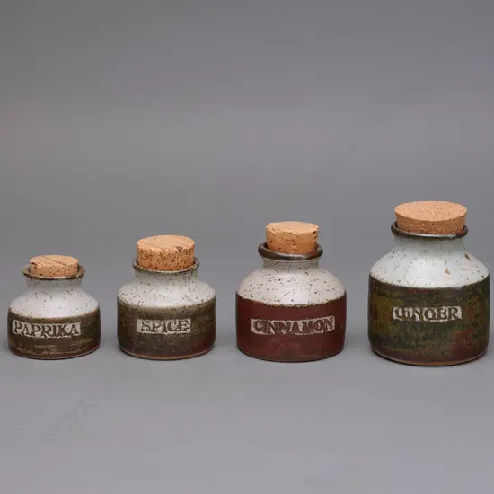 A set of seven Len Castle stoneware herb/spice jars,